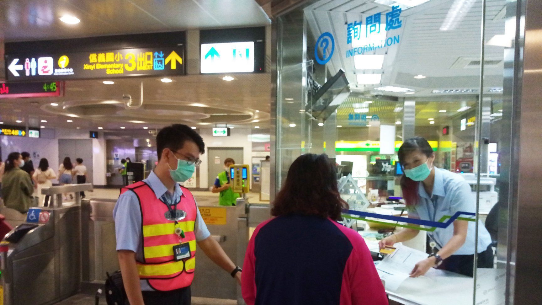 Staff and passenger in front of a MRT information booth
