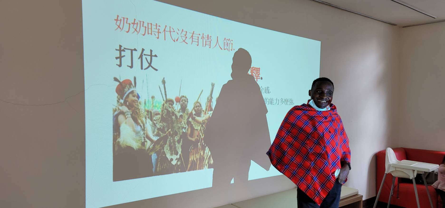 Lecturer introducing traditional Kenyan clothing