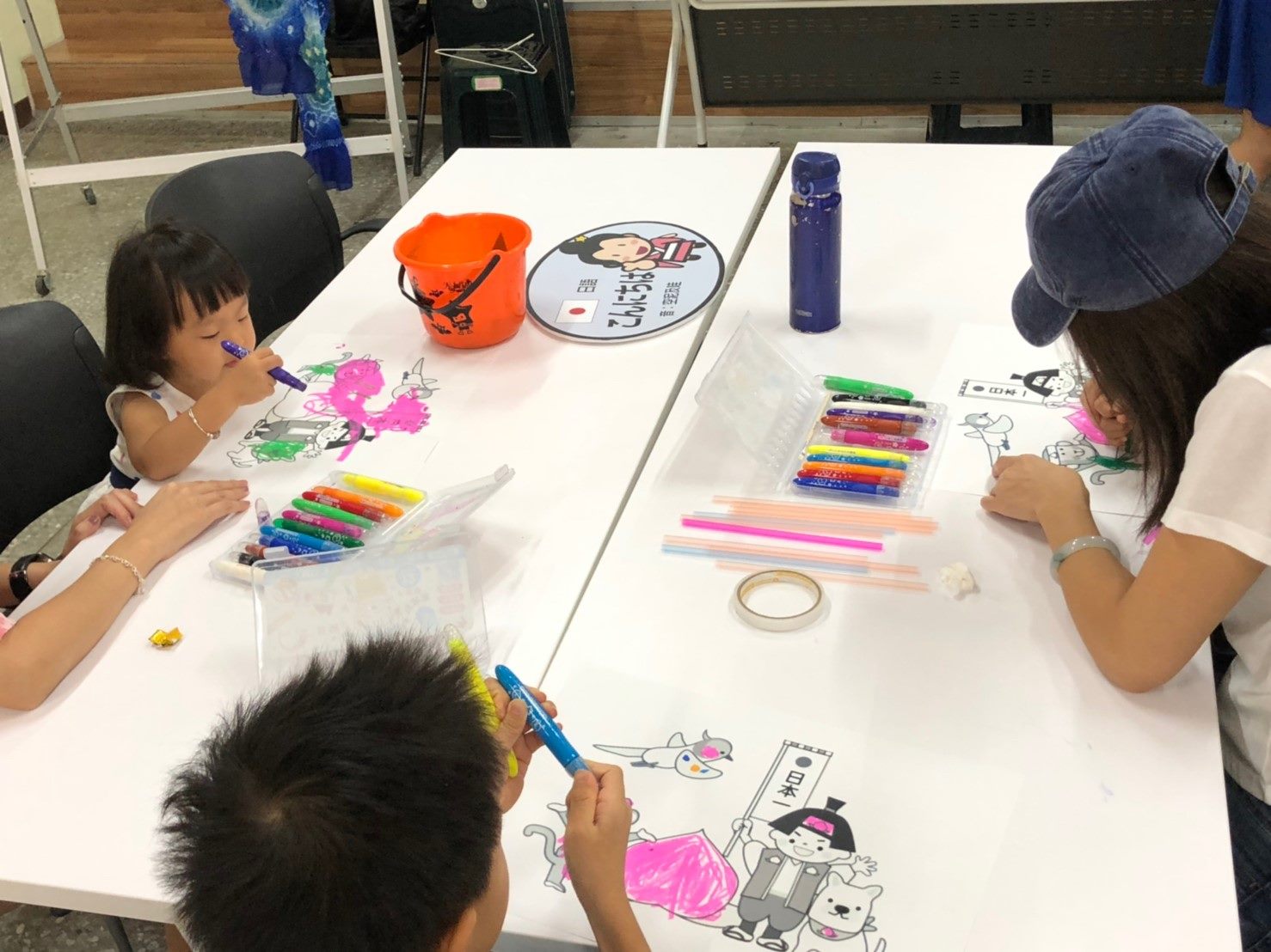 Parents and children making Momotarō kite together