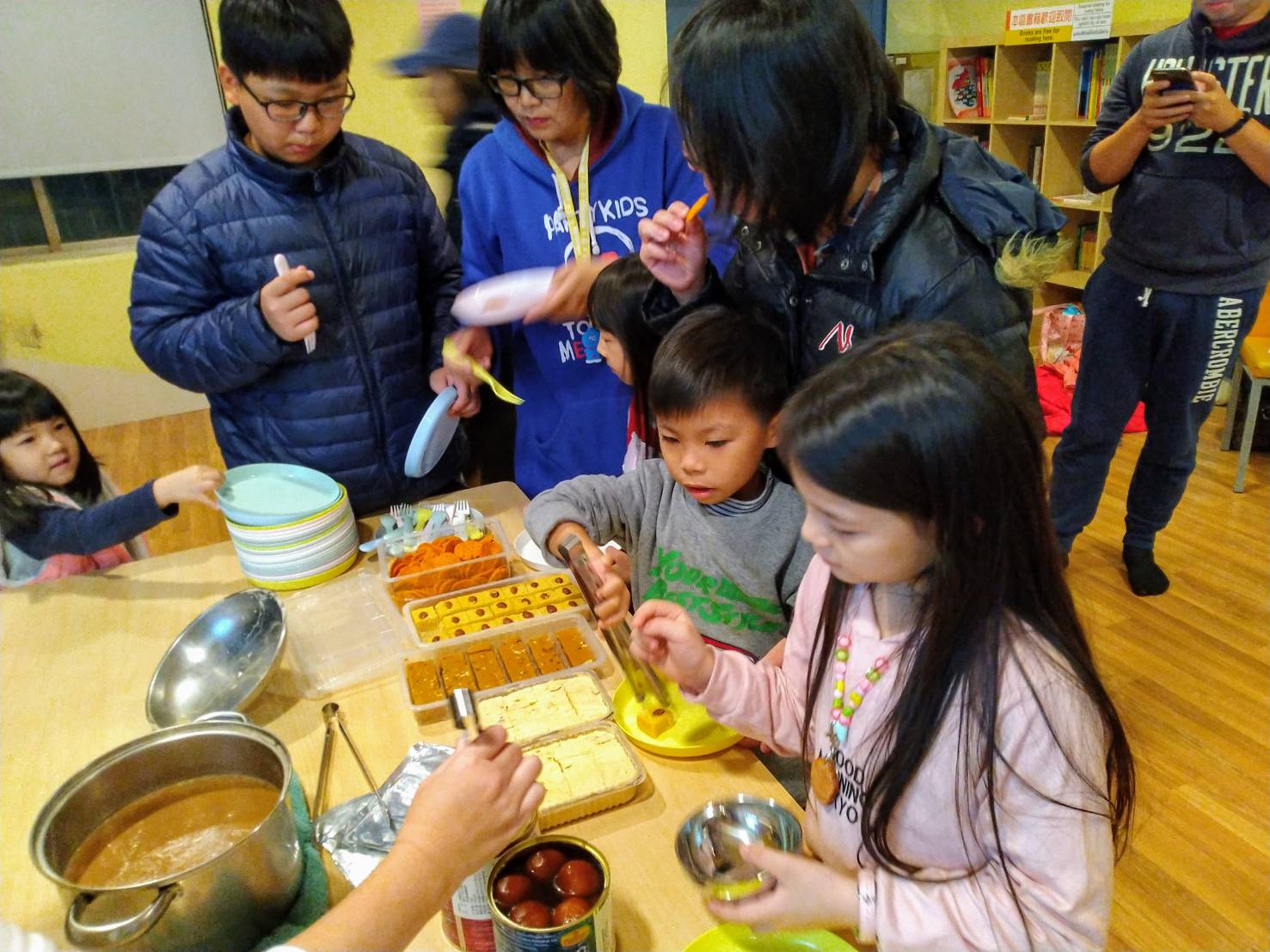 Participants sharing Indian dessert together  ​