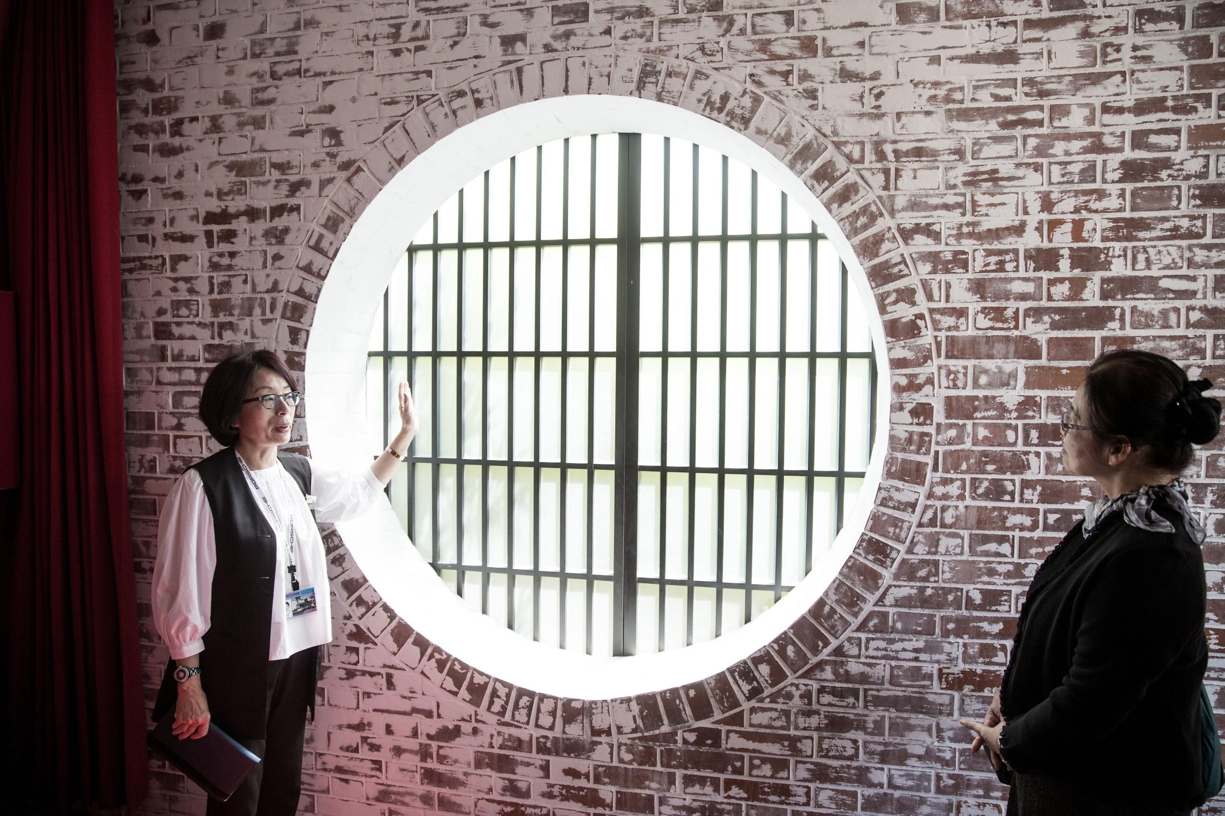 Round windows and exposed brick give an oriental flavor to the modernist house.