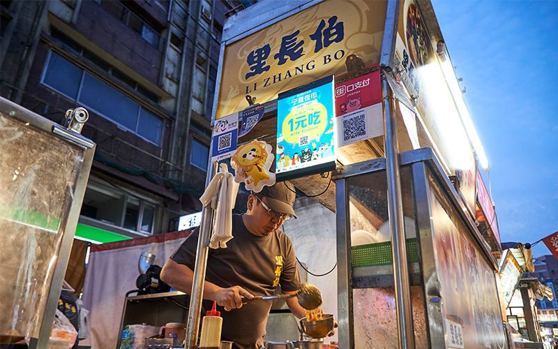 老闆李啟榮兼顧夜市攤位和店面，把小吃當事業經營。