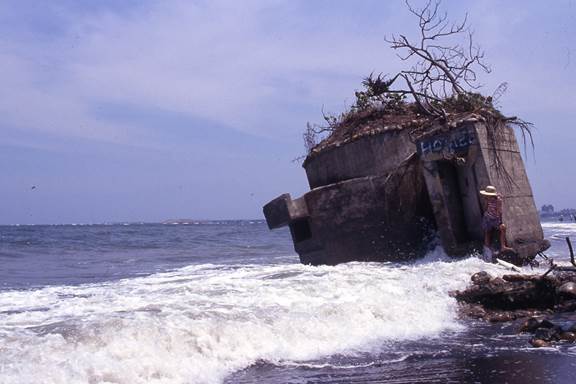 Severe coastal erosion causing the collapse in 1993 of a coastal fortress in Bali District, Taipei.