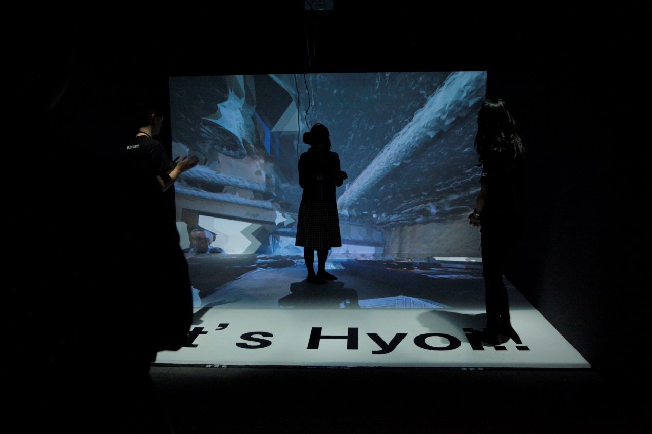 One viewer manipulates an interactive art installation with a sensor and head-mounted device at the MOCA Taipei.